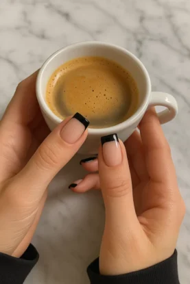 a black nail hand with a tea cup