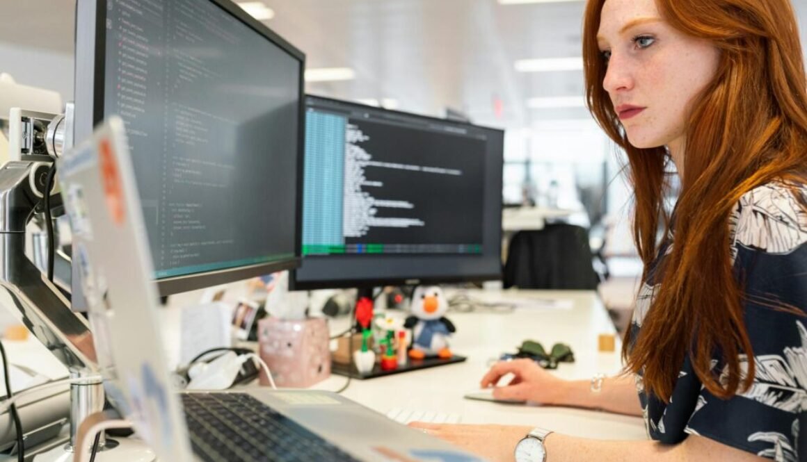 women working on laptop in office